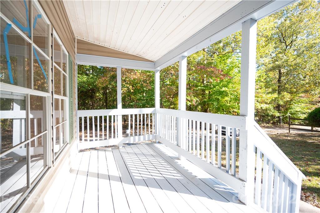 6550 Lewis Road Kings Mountain, NC 28086 - Photo 4 of 20 a view of a two chairs with wooden floor and fence