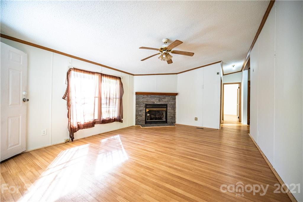 6550 Lewis Road Kings Mountain, NC 28086 - Photo 8 of 20 a view of an empty room with a fireplace and a window