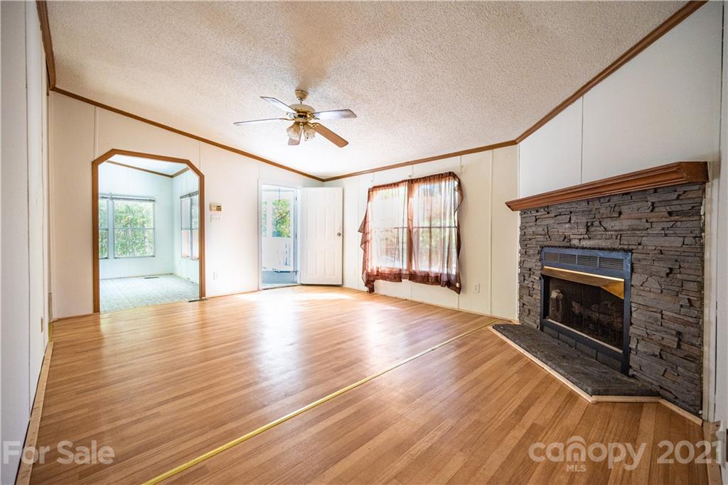 6550 Lewis Road Kings Mountain, NC 28086 - Photo 10 of 20 a view of an empty room with a fireplace and a window