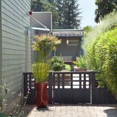 a view of a chairs and table in the backyard