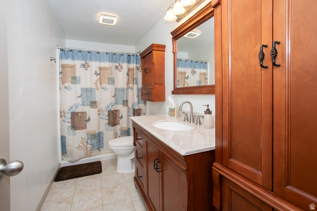 426 Deer Hollow Road Tooele, UT 84074 - Photo 25 of 37 Full bathroom featuring a shower with curtain, vanity, and light tile patterned floors