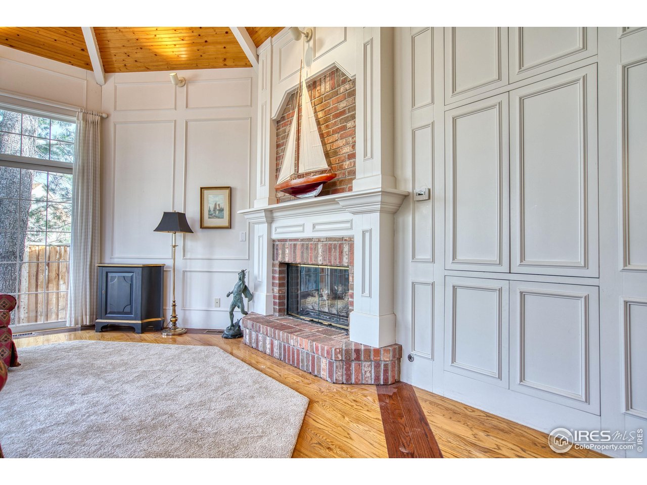 4471 Wellington Road Boulder, CO 80301 - Photo 12 of 42 a living room with furniture a fireplace and a window