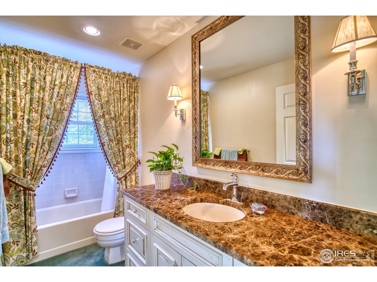 4471 Wellington Road Boulder, CO 80301 - Photo 24 of 42 a bathroom with a granite countertop sink and a mirror