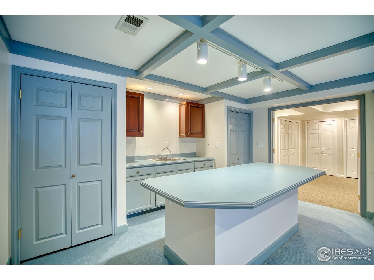 4471 Wellington Road Boulder, CO 80301 - Photo 28 of 42 a kitchen with cabinets and wooden floor