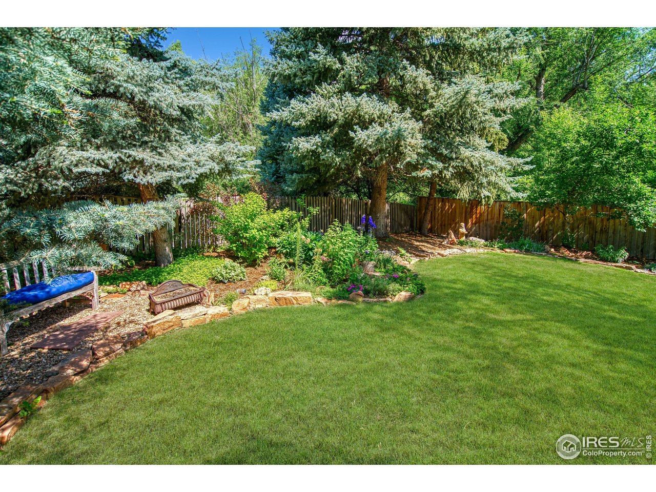 4471 Wellington Road Boulder, CO 80301 - Photo 38 of 42 a view of a backyard with plants and a bench