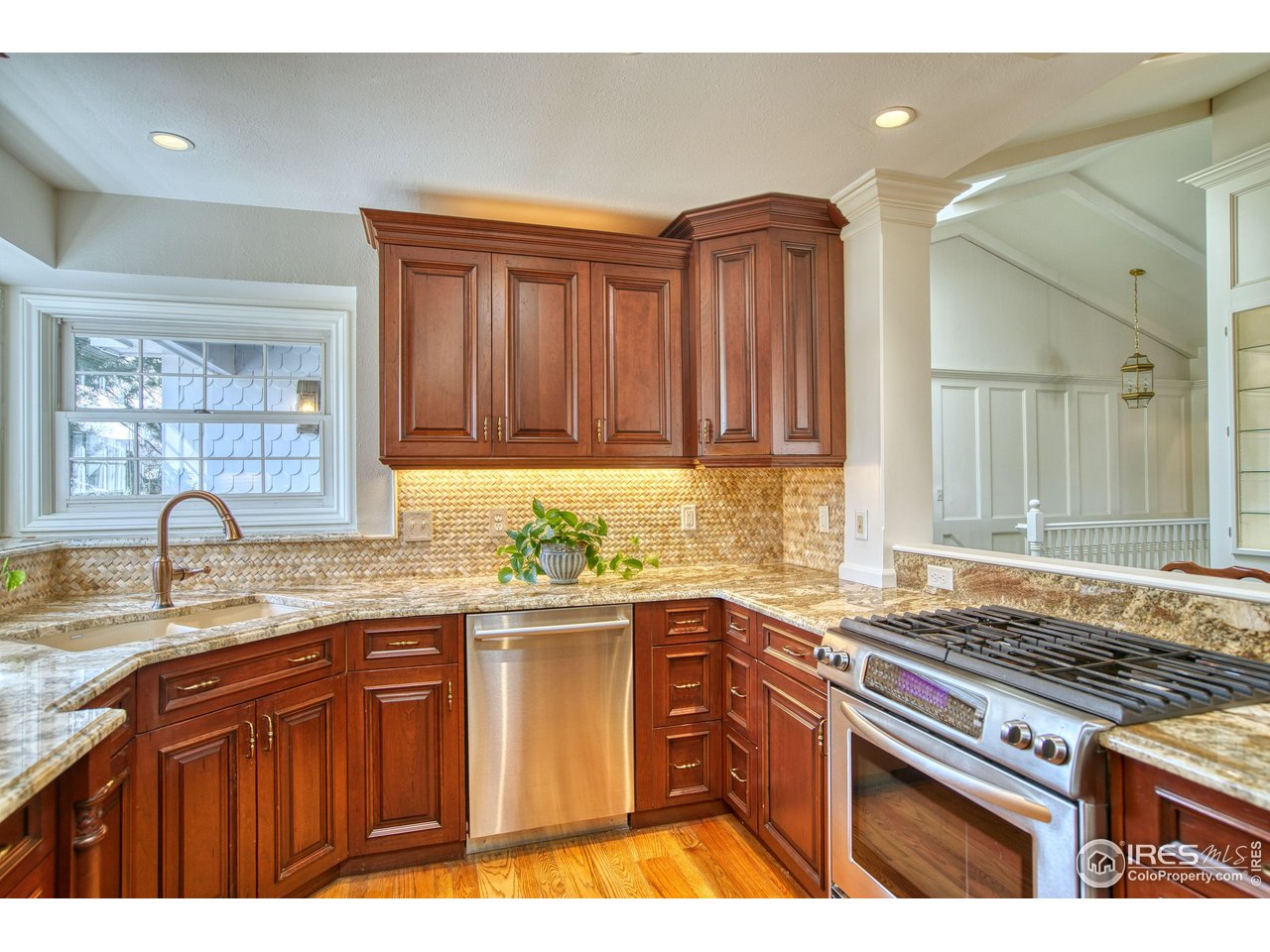 4471 Wellington Road Boulder, CO 80301 - Photo 7 of 42 a kitchen with granite countertop stainless steel appliances a sink stove and cabinets
