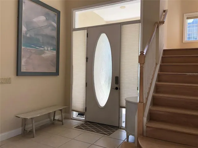 a view of entryway with wooden floor and glass door