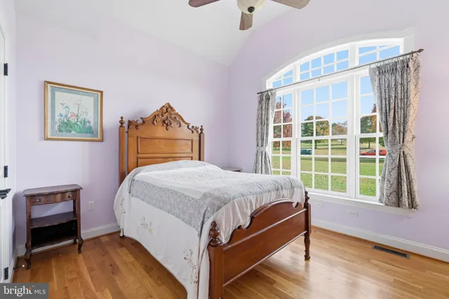 a bed sitting in a bedroom next to a window