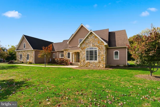 a front view of a house with a yard porch and outdoor seating