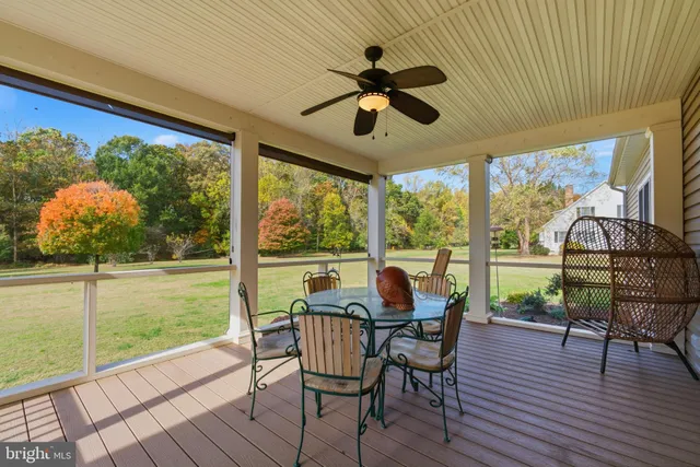 a view of a porch with furniture and wooden floor