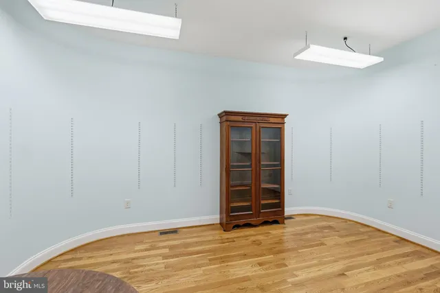 a view of an empty room with closet and a window