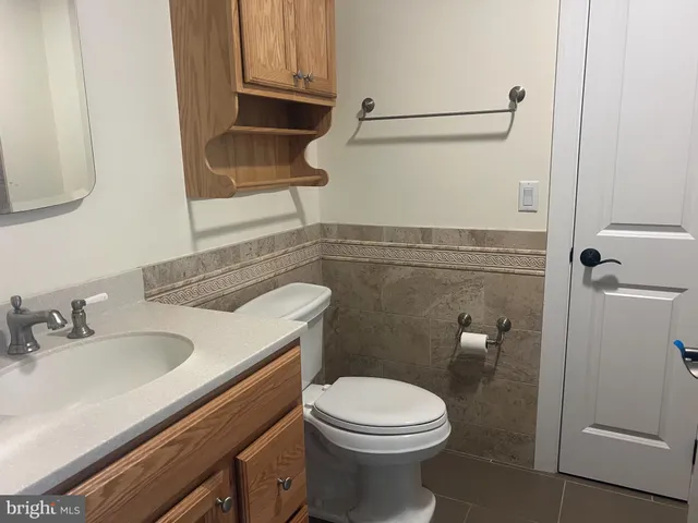 a bathroom with a sink a toilet and vanity