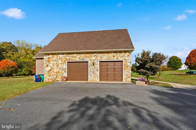 a view of a house with a yard and garage