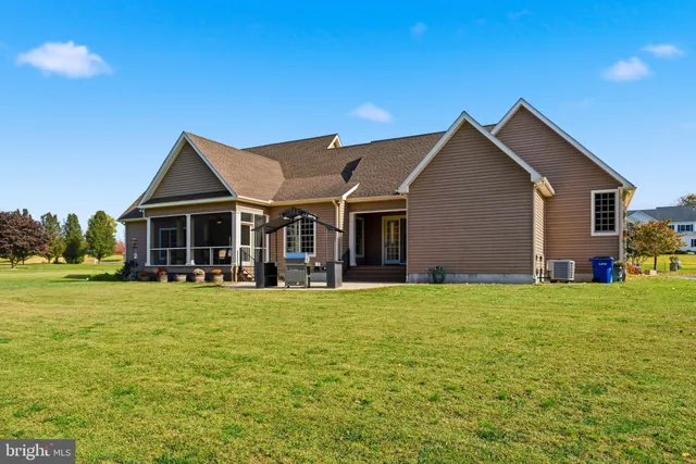 a front view of house with yard barbeque and outdoor seating