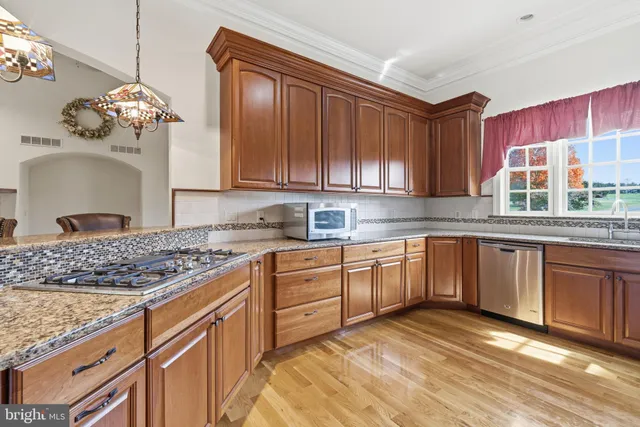 a kitchen with stainless steel appliances granite countertop a cabinets sink and stove