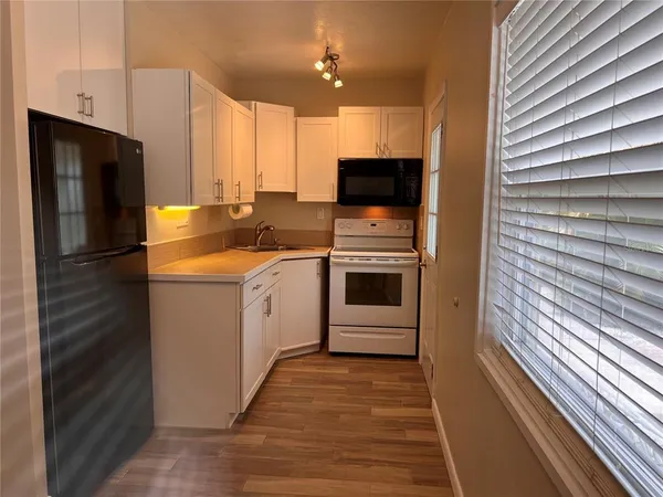 a kitchen with a sink stainless steel appliances and cabinets
