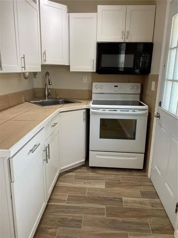 a kitchen with a stove and a sink