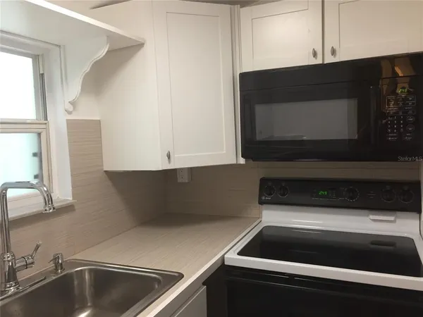 a kitchen with a sink and a microwave