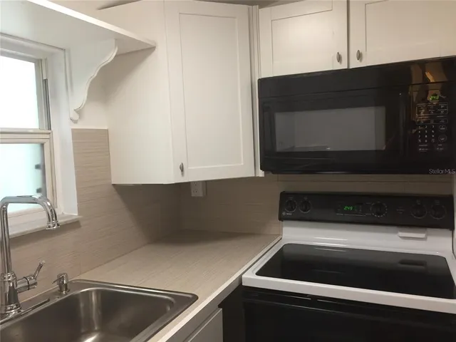a kitchen with a sink and a microwave