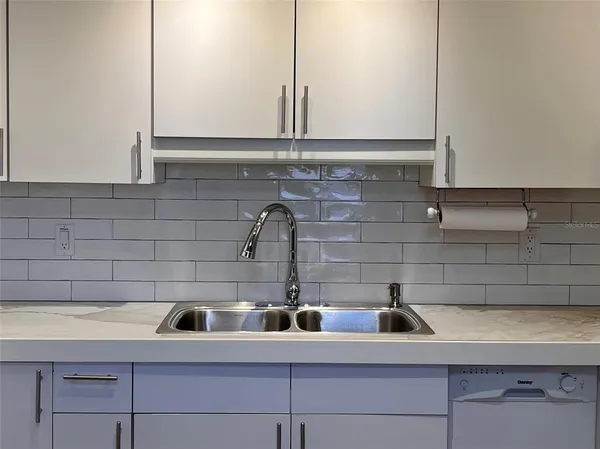 a kitchen with a sink and cabinets