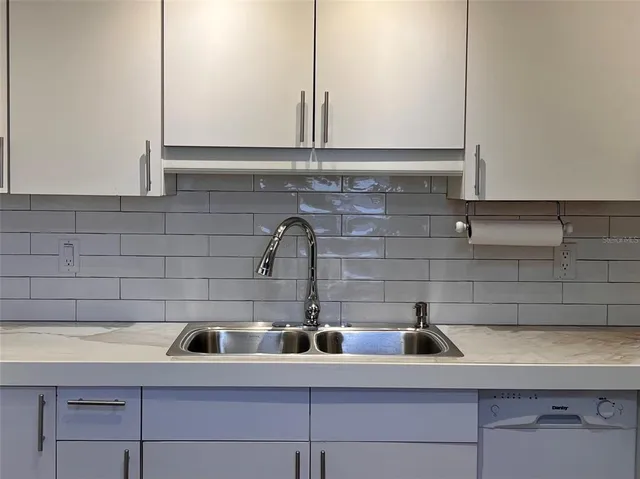a kitchen with a sink and cabinets