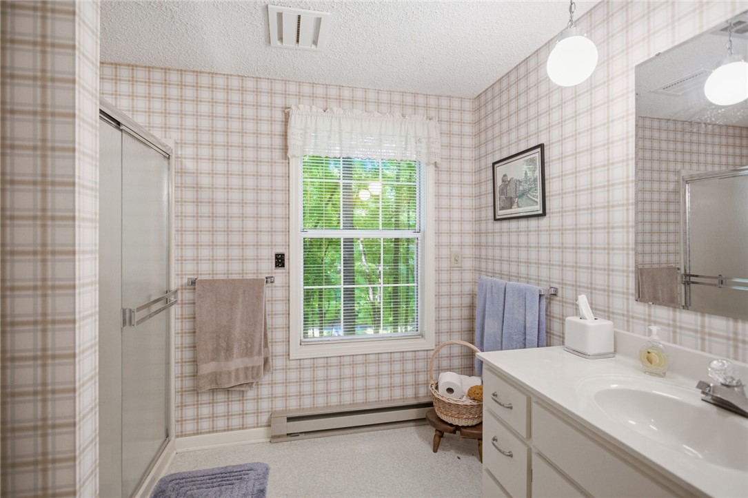 6 Tradewinds Way Salem, SC 29676 - Photo 22 of 50 This bathroom features a single vanity, a shower, and a large window providing natural light.