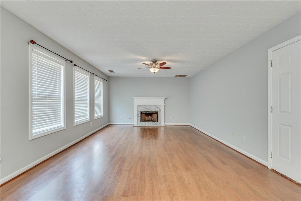 3337 Baymount Way Lawrenceville, GA 30043 - Photo 18 of 47 a view of an empty room with wooden floor and a window