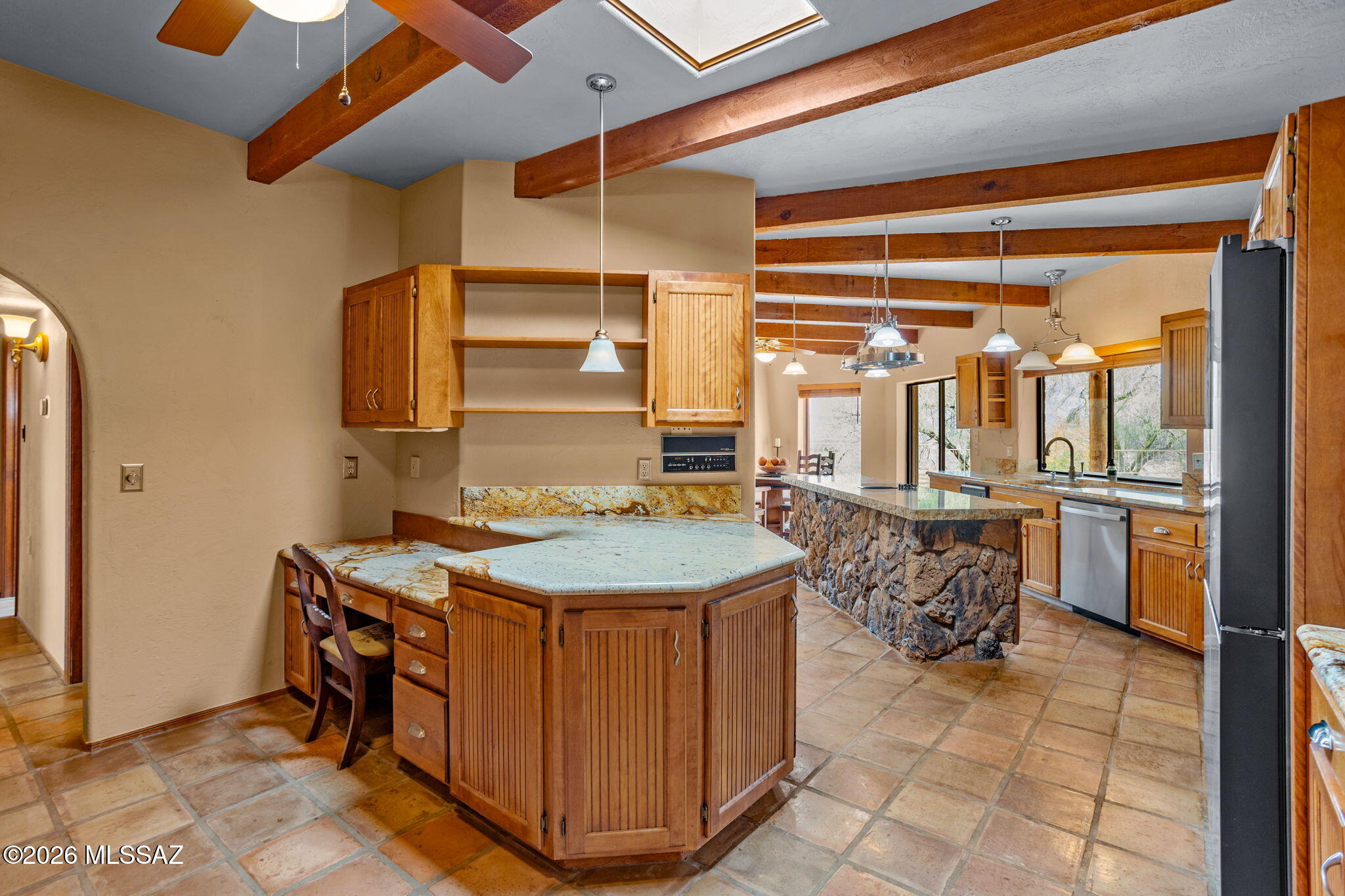 7171 South X9 Ranch Road Vail, AZ 85641 - Photo 5 of 50 Skylight, ceiling fan, custom cabinetry. hallway to Bdrms 4 & 5 & garage