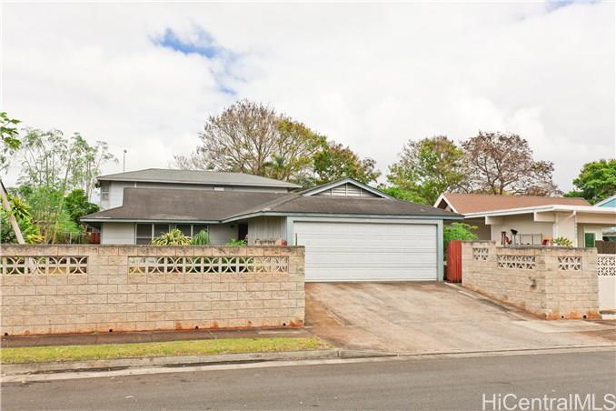 94-513 Hokuala Street Mililani, HI 96789 - Photo 1 of 1 a front view of a house with a garden and garage