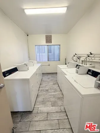 a room with a washing machine and sink