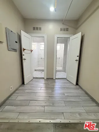 a view of a hallway with wooden floor