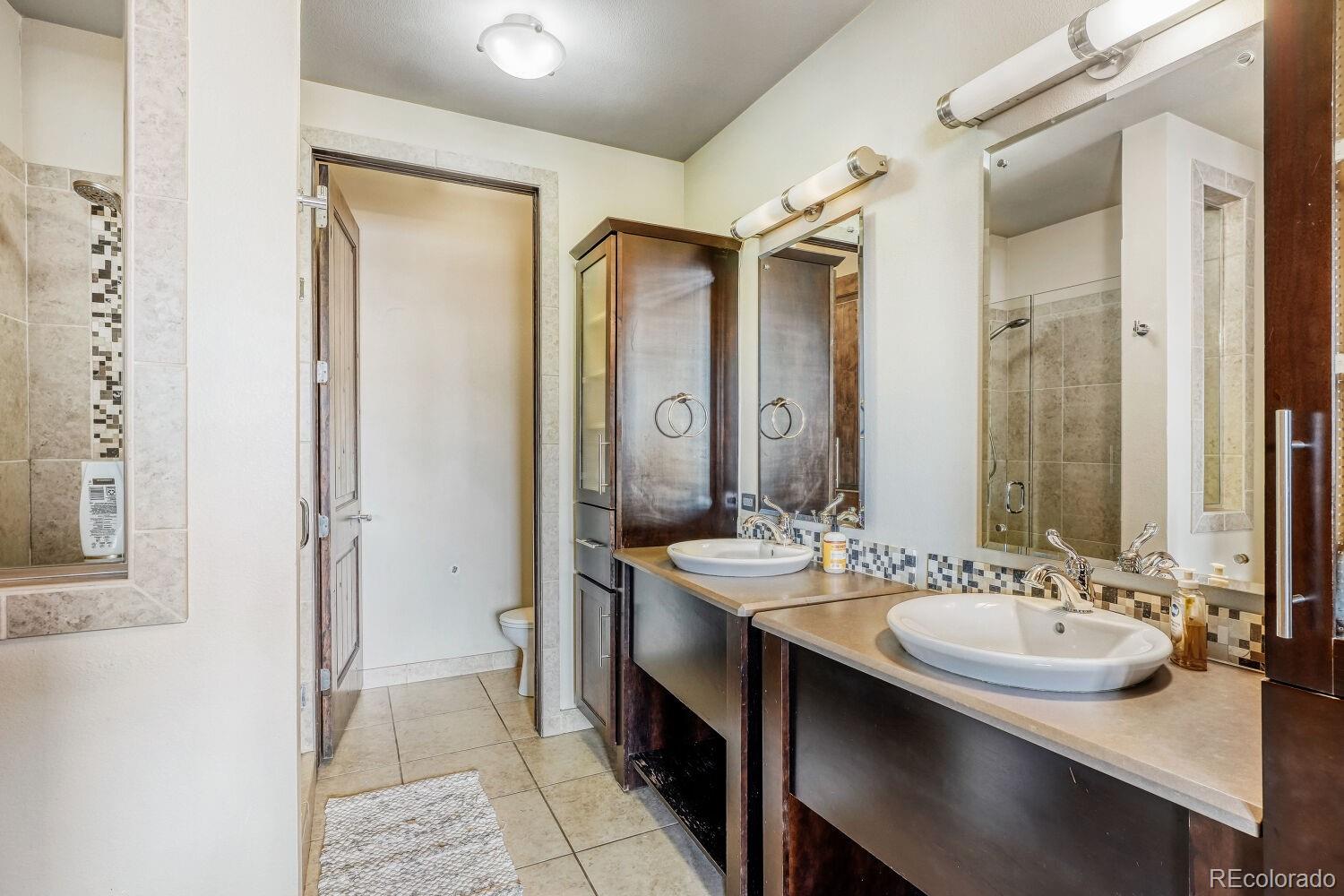 2101 Larimer Street, Unit 303 Denver, CO 80205 - Photo 13 of 21 a bathroom with a sink and a mirror