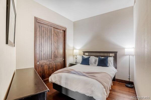 2101 Larimer Street, Unit 303 Denver, CO 80205 - Photo 17 of 21 a bedroom with a bed and a night stand