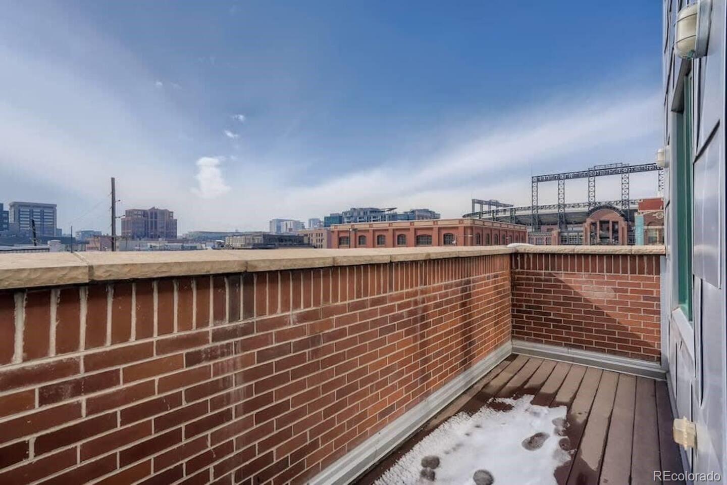 2101 Larimer Street, Unit 303 Denver, CO 80205 - Photo 20 of 21 a view of balcony with wooden floor