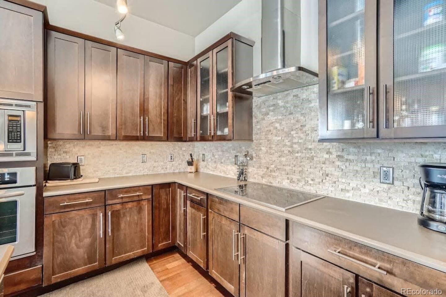 2101 Larimer Street, Unit 303 Denver, CO 80205 - Photo 4 of 21 a kitchen with a sink cabinets and window