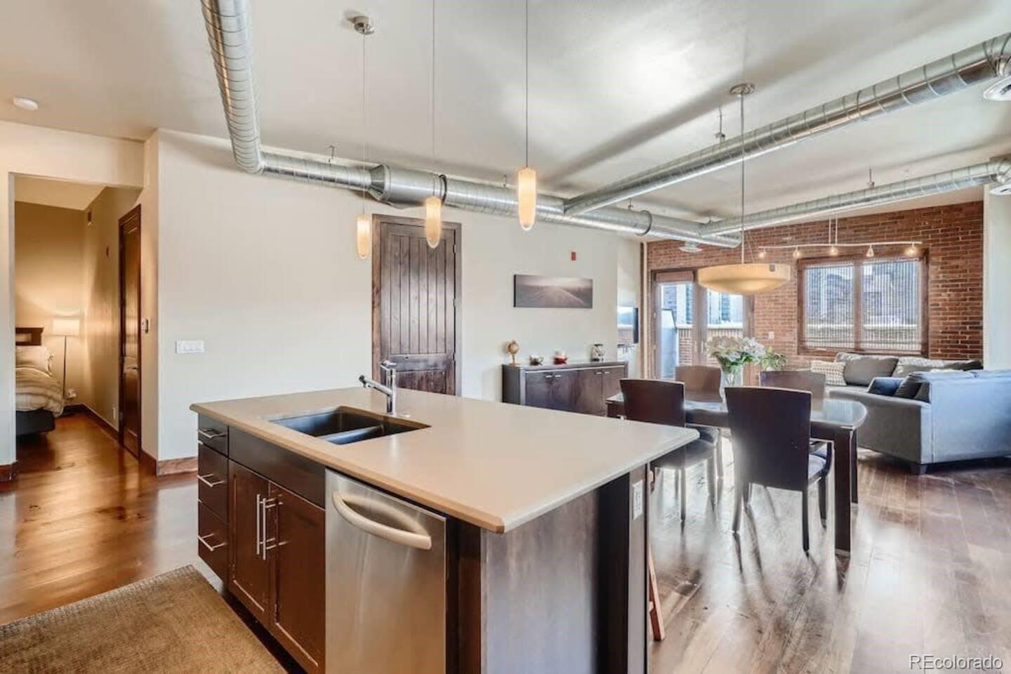 2101 Larimer Street, Unit 303 Denver, CO 80205 - Photo 5 of 21 a kitchen that has a table and chairs in it