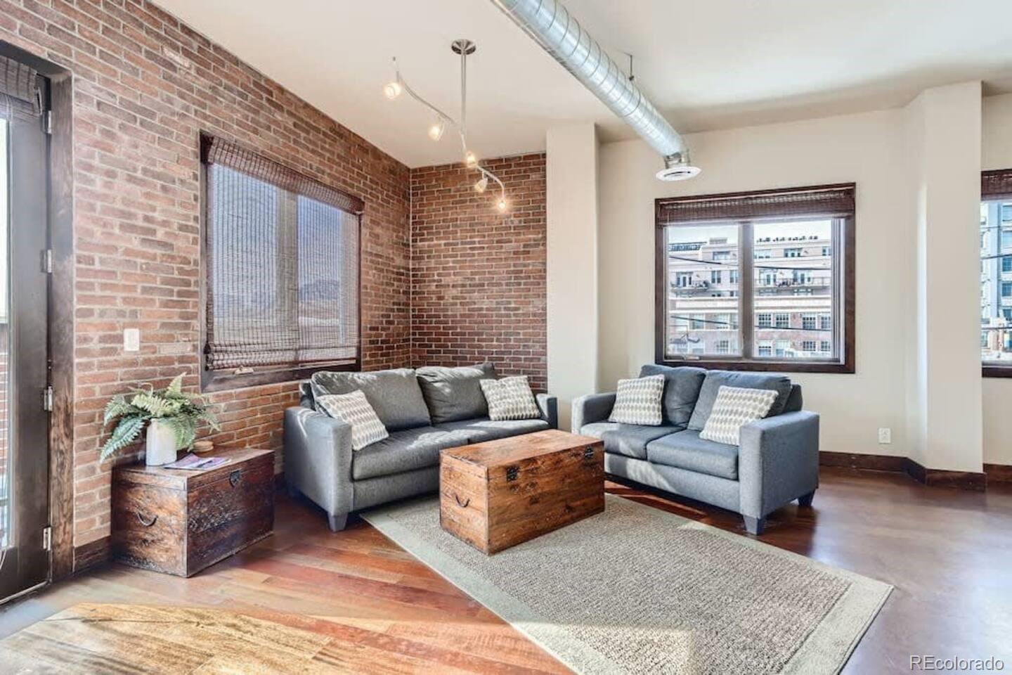 2101 Larimer Street, Unit 303 Denver, CO 80205 - Photo 9 of 21 a living room with furniture and a large window