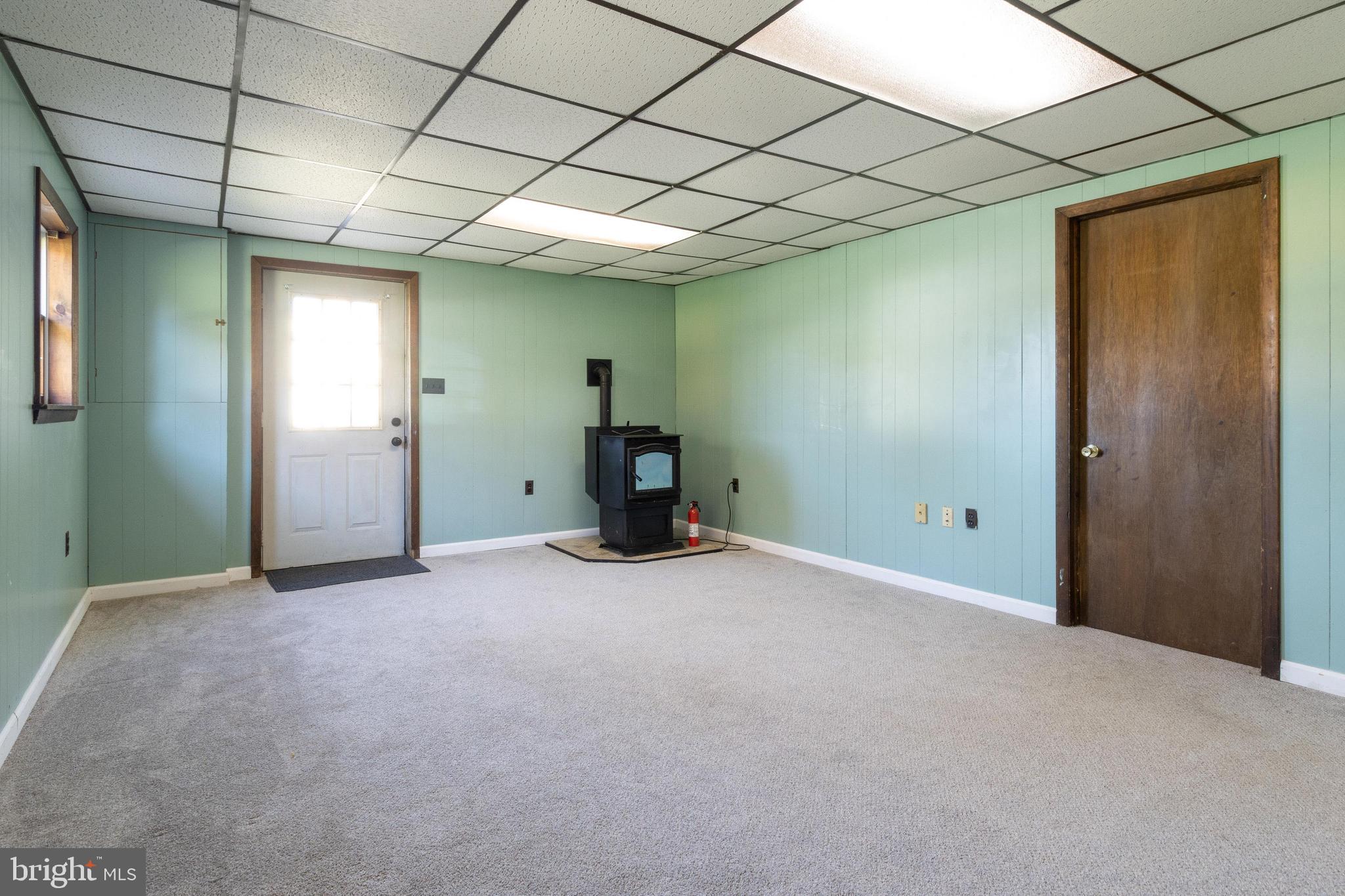 3447 Augusta Road Manchester, MD 21102 - Photo 27 of 41 Family room has a pellet stove and carpet.