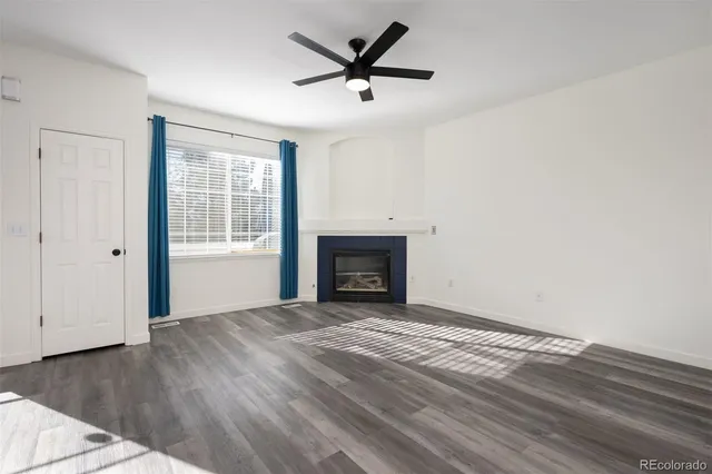 wooden floor in an empty room with a fireplace