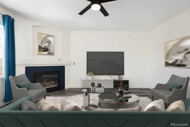 a living room with furniture a fireplace and a flat screen tv