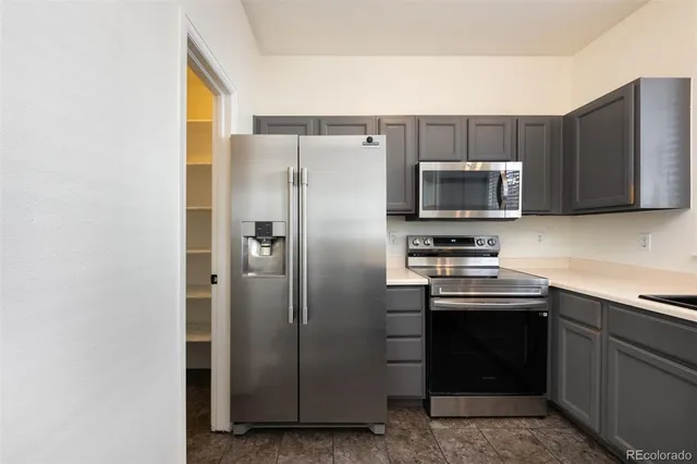 a kitchen with stainless steel appliances a refrigerator and a sink