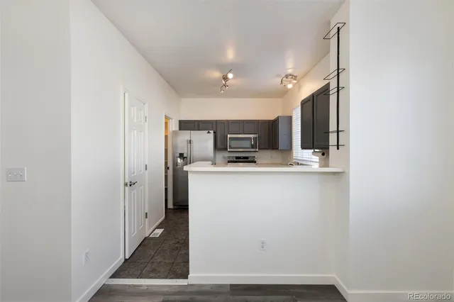 a view of a kitchen with electric appliances