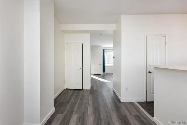 a view of a room with wooden floor and a bathroom