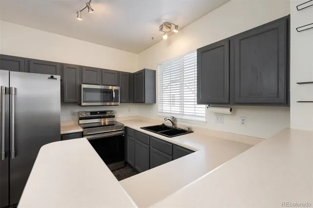 a kitchen that has a sink and a stove top oven