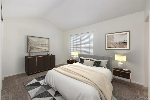 a bedroom with a bed and painting on the wall