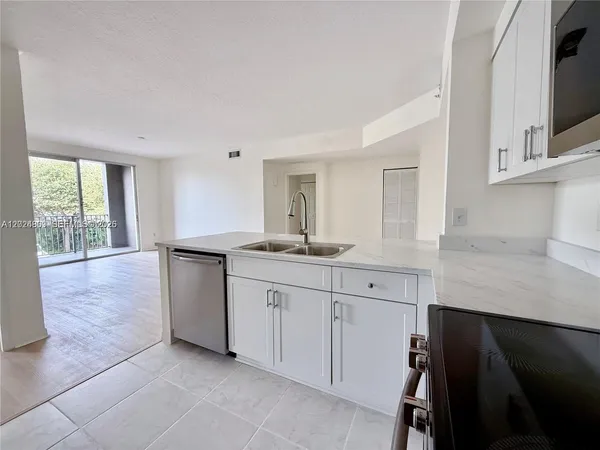 a spacious bathroom with a granite countertop sink a mirror and a bathtub