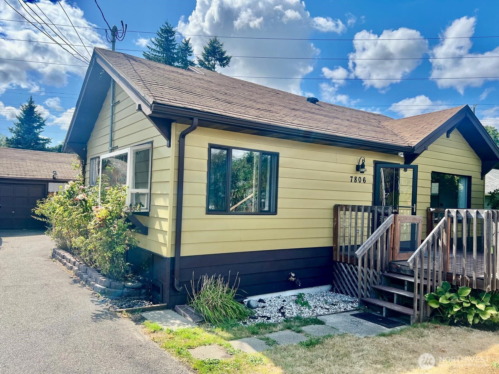7806 Beverly Boulevard Everett, WA 98203 - Photo 1 of 22 a view of a house with wooden fence next to a yard