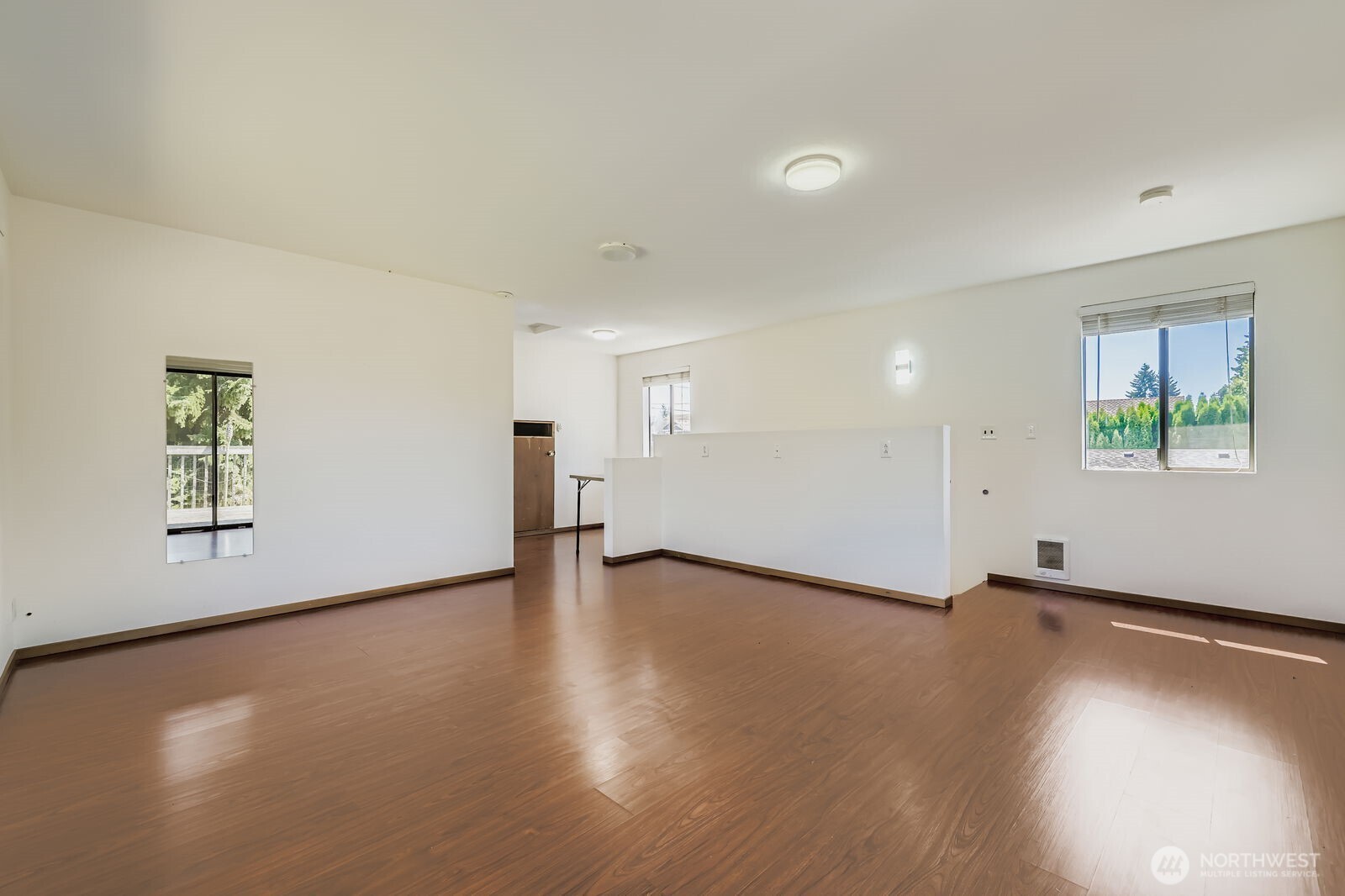 7806 Beverly Boulevard Everett, WA 98203 - Photo 16 of 22 an empty room with wooden floor and windows