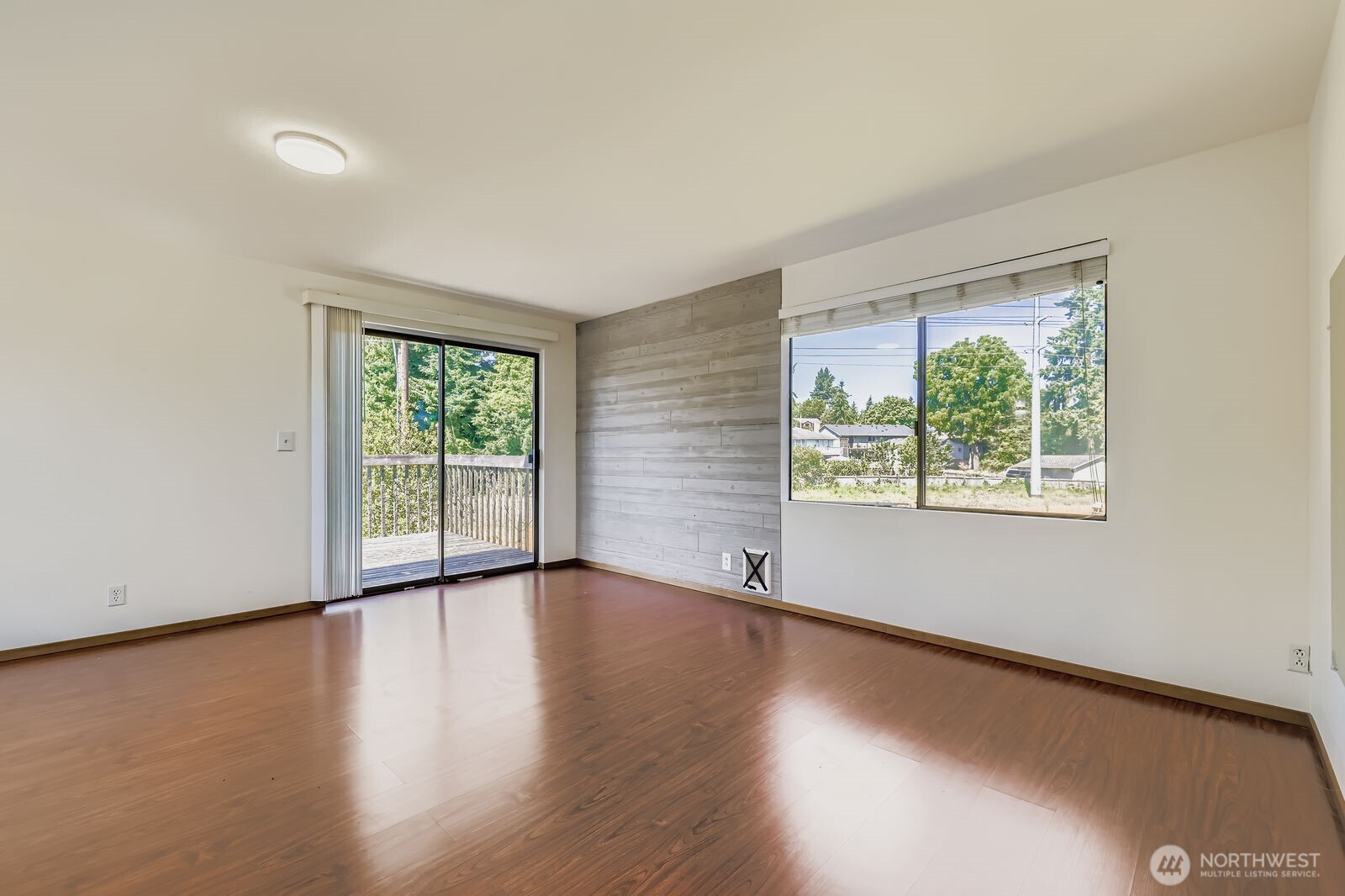 7806 Beverly Boulevard Everett, WA 98203 - Photo 17 of 22 a view of an empty room with wooden floor and a window