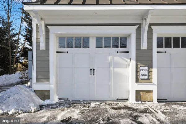 a view of house in front of a yard with potted plants